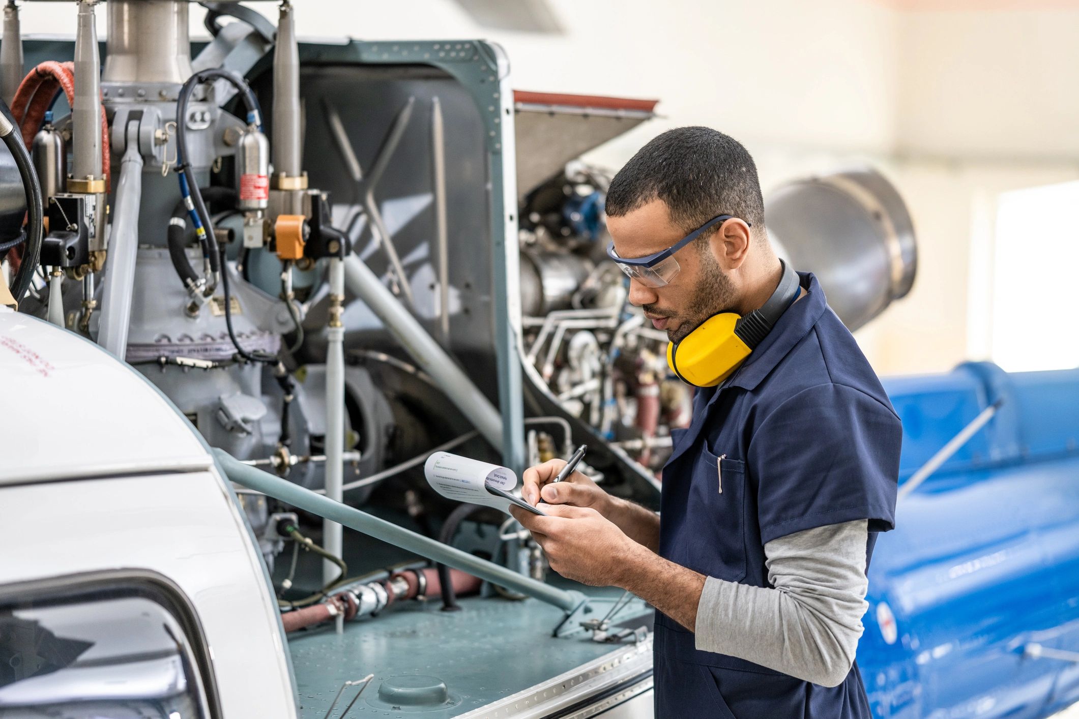 Technician inspecting complex industrial equipment
